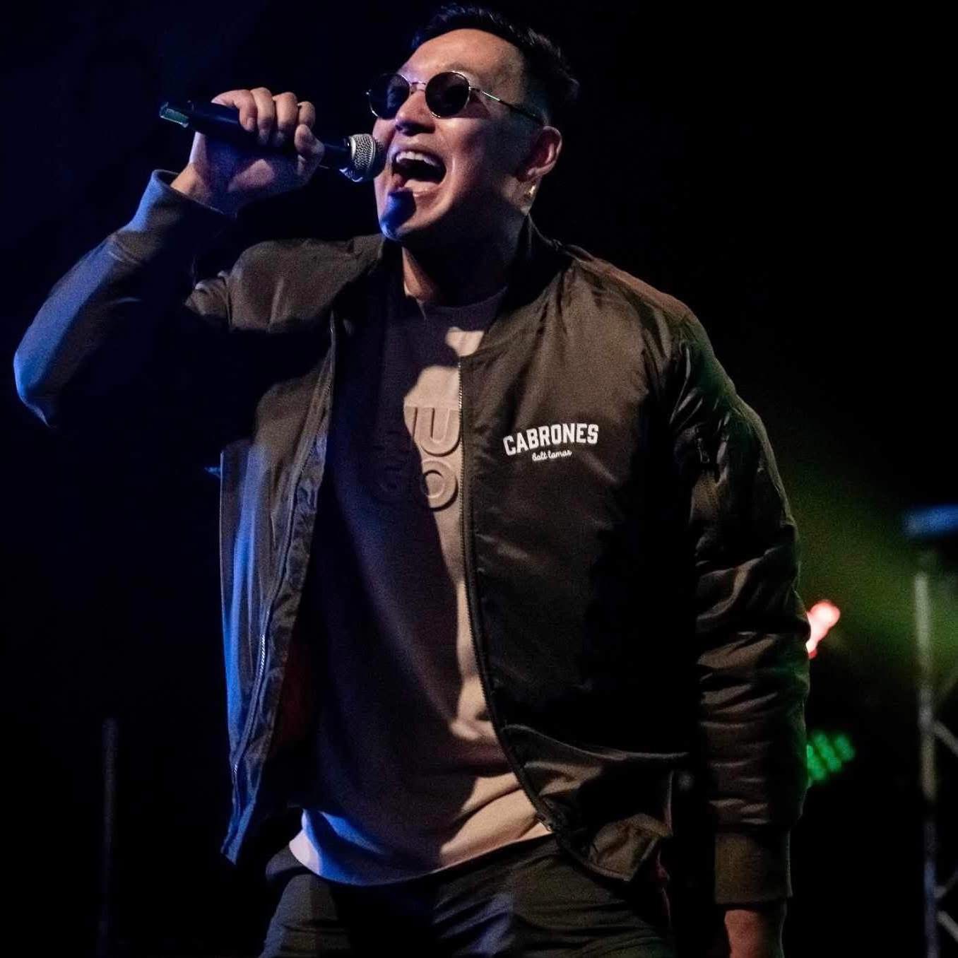 Pilut on stage singing into a microphone