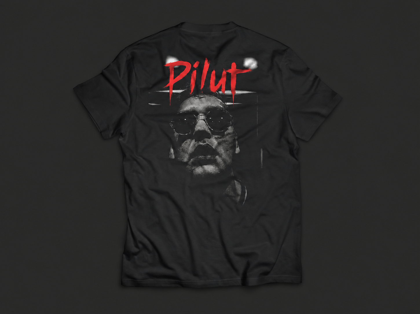 Back of the black Pilut T-shirt, with a portrait and red Pilut lettering