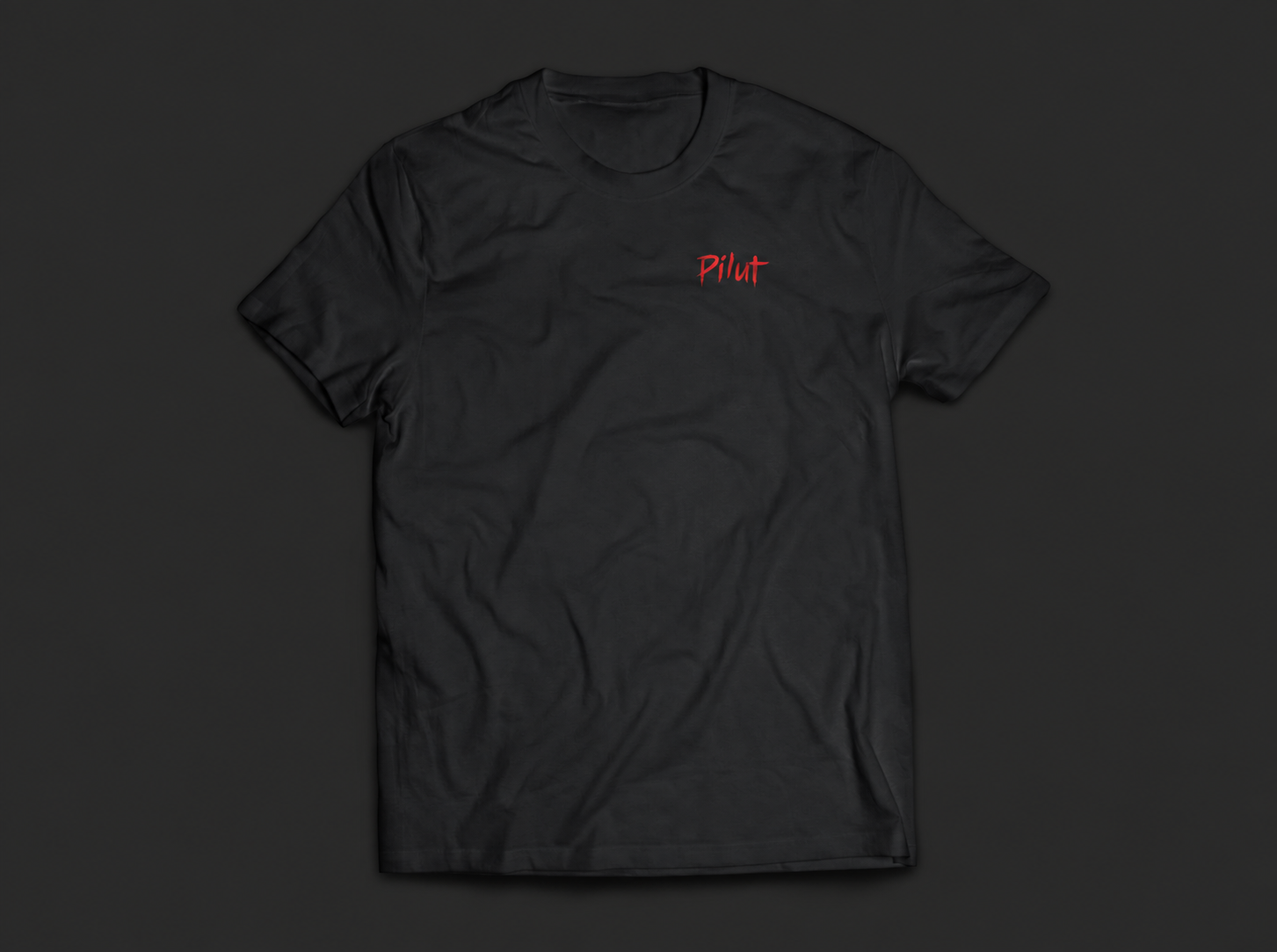 Front of the black Pilut T-shirt, with a small red logo