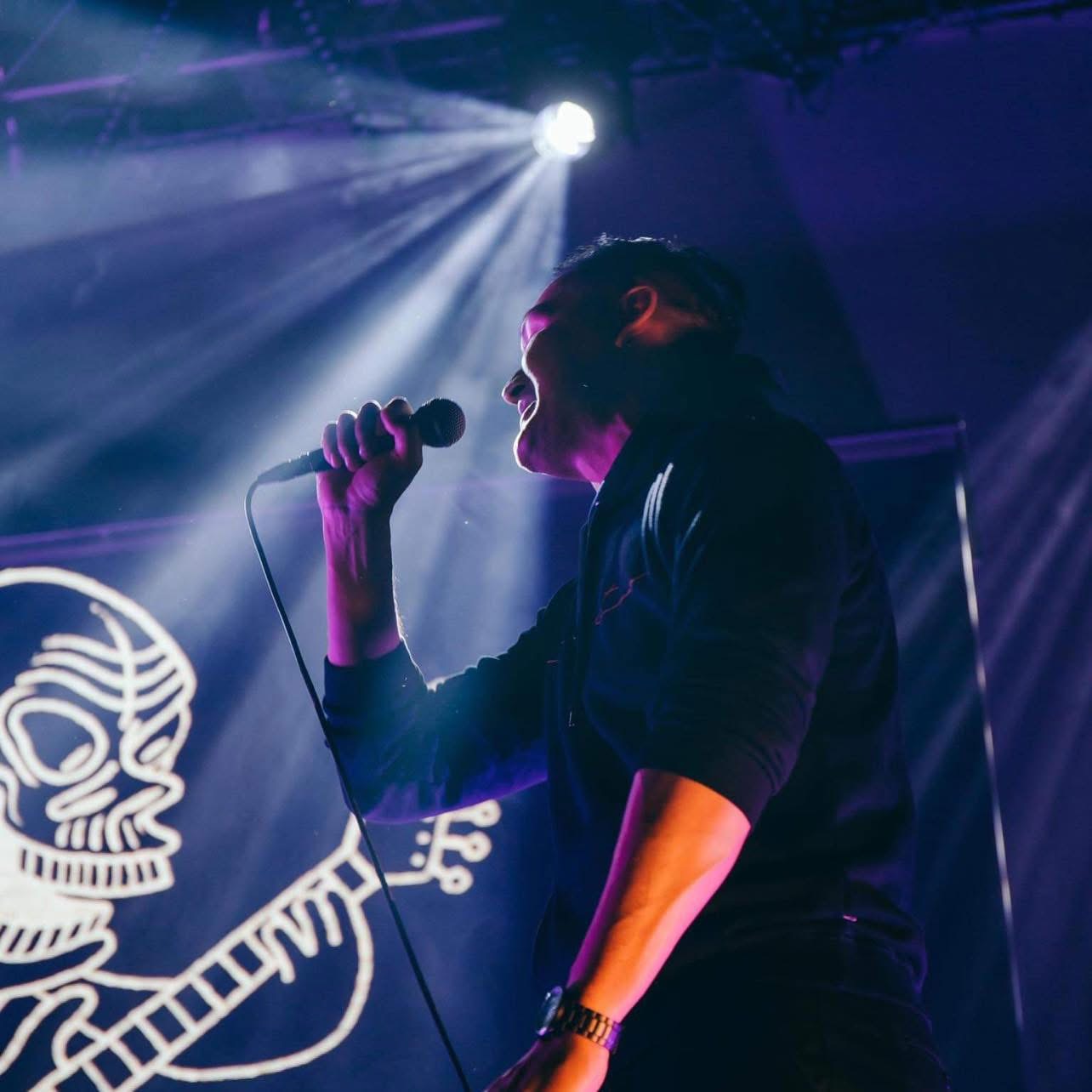 Pilut performing on a lit stage